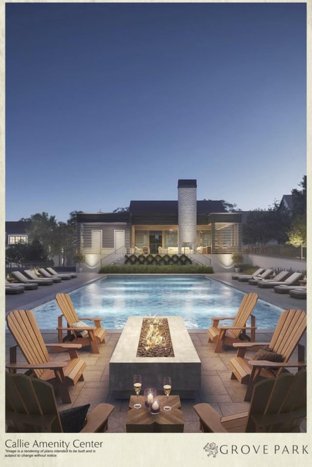 view of swimming pool with a patio area and a fire pit