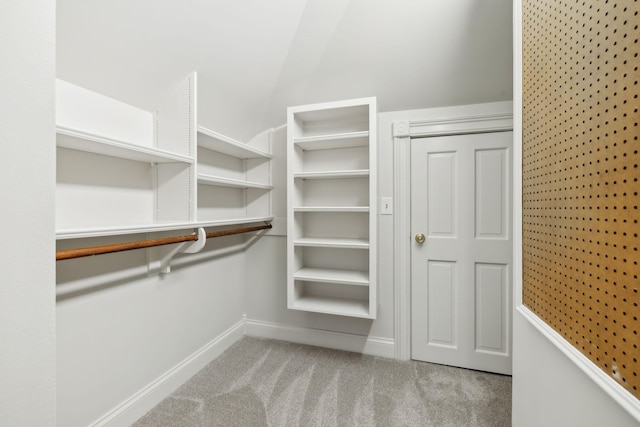 walk in closet featuring light carpet