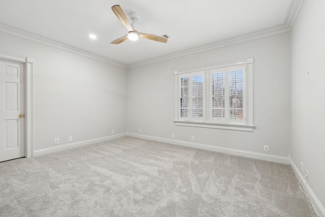 spare room featuring ceiling fan, ornamental molding, and light carpet