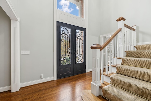 entryway featuring a high ceiling, french doors, and dark hardwood / wood-style flooring