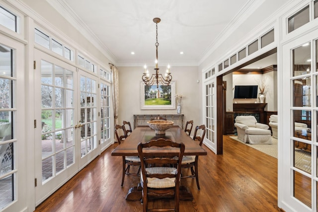 dining area with ornamental molding, a notable chandelier, and french doors