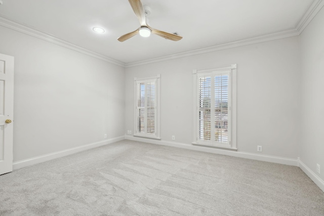 carpeted empty room featuring ceiling fan and crown molding