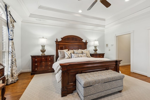 bedroom with ceiling fan, crown molding, and light hardwood / wood-style flooring