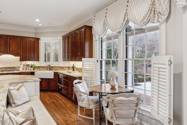 kitchen featuring dark hardwood / wood-style flooring, light stone countertops, tasteful backsplash, and sink