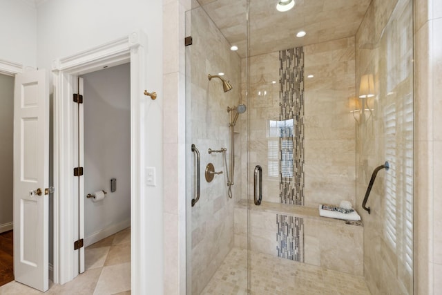 bathroom with walk in shower and tile patterned flooring