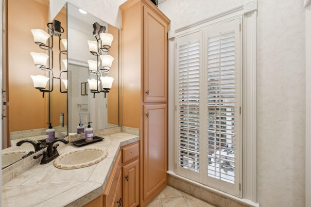 bathroom with ornamental molding, tile patterned floors, and vanity