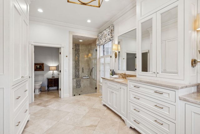 bathroom with toilet, vanity, a shower with shower door, and crown molding