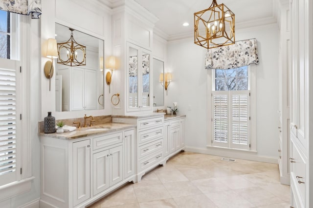 bathroom featuring tile patterned floors, a notable chandelier, crown molding, and vanity