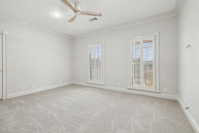 carpeted spare room with ceiling fan and crown molding