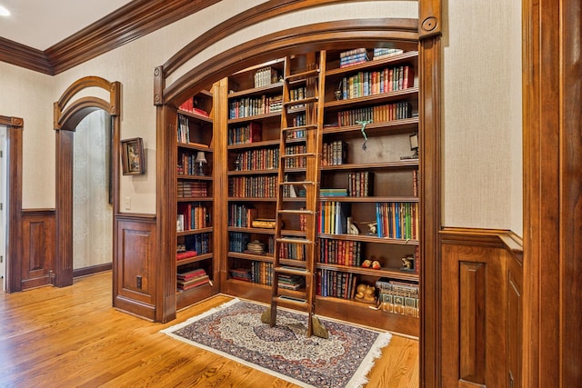 interior space featuring wood-type flooring and crown molding