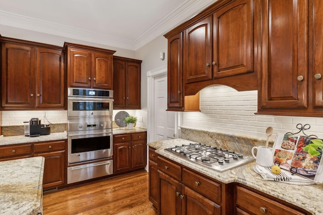 kitchen with ornamental molding, stainless steel appliances, dark hardwood / wood-style flooring, and decorative backsplash