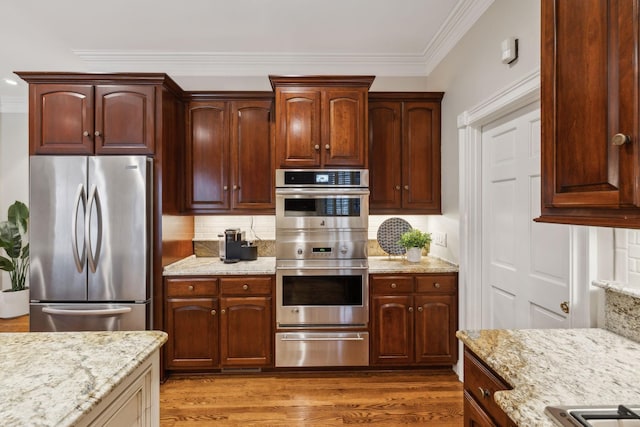 kitchen with stainless steel appliances, light stone counters, ornamental molding, tasteful backsplash, and dark hardwood / wood-style flooring