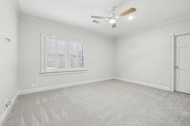 carpeted spare room with ornamental molding and ceiling fan