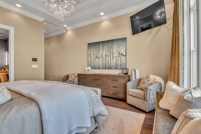 bedroom with a notable chandelier, crown molding, and dark hardwood / wood-style floors