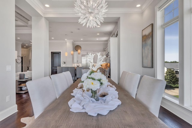 dining room featuring dark wood-type flooring, crown molding, and a chandelier