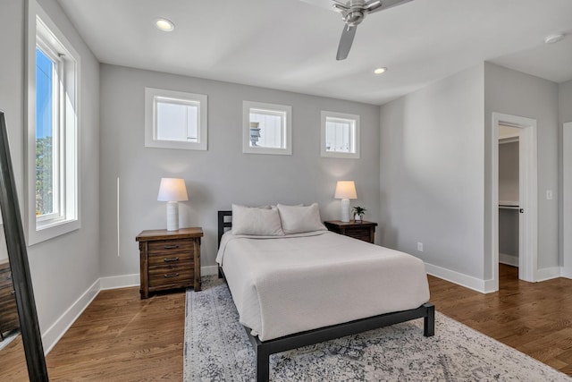 bedroom with ceiling fan and hardwood / wood-style flooring