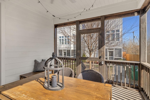 sunroom / solarium featuring rail lighting