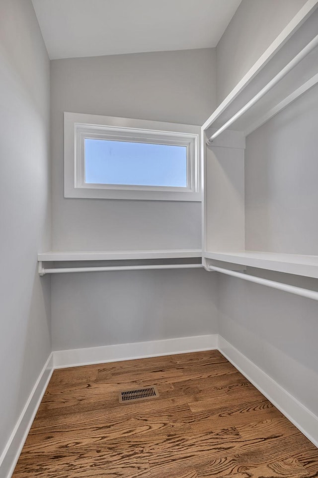 spacious closet with hardwood / wood-style flooring