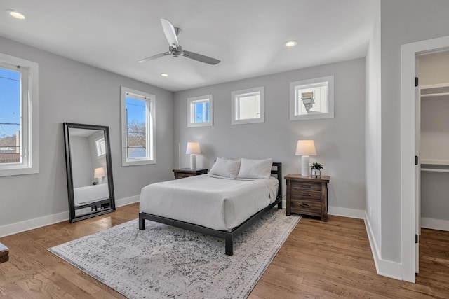 bedroom with ceiling fan and light hardwood / wood-style floors