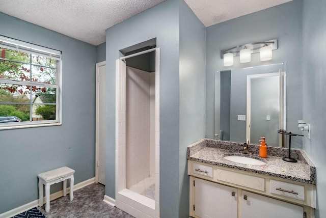 bathroom with a textured ceiling, a shower with shower curtain, and vanity