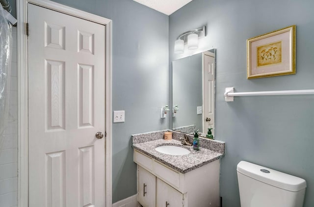 bathroom featuring toilet and vanity