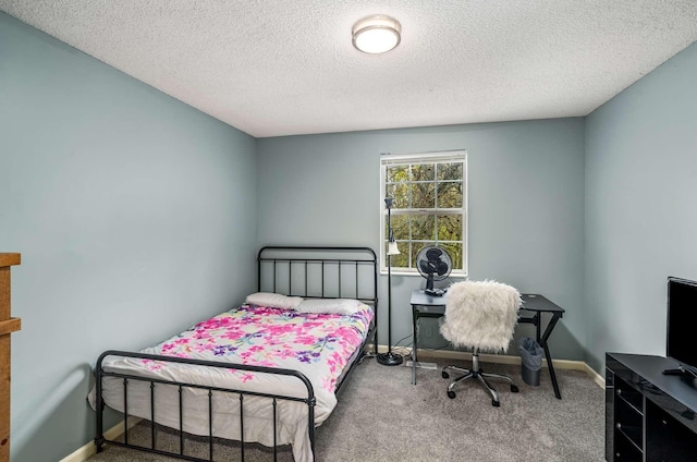 bedroom featuring a textured ceiling and carpet