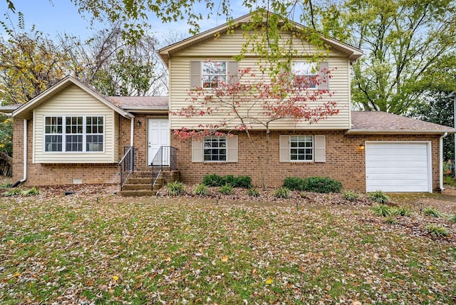 tri-level home featuring a front yard and a garage