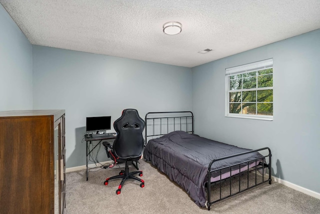 carpeted bedroom featuring a textured ceiling