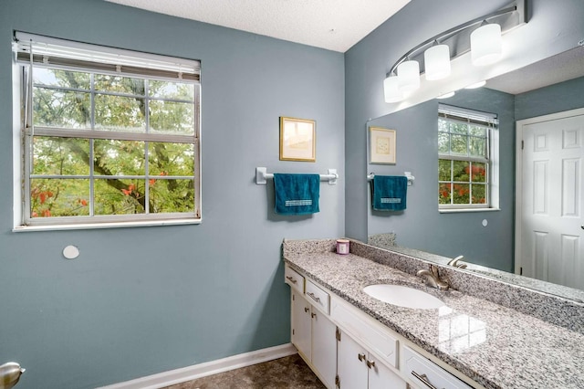 bathroom with a textured ceiling and vanity