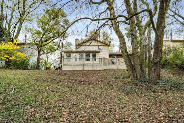 rear view of house featuring a wooden deck