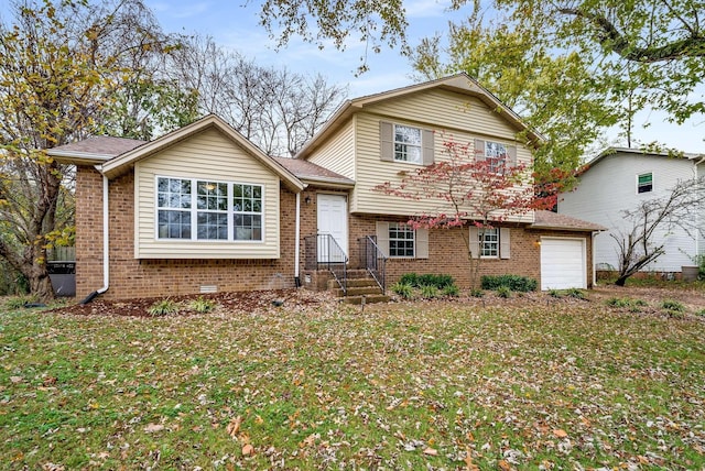 tri-level home with a front yard and a garage