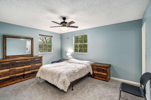 carpeted bedroom with a textured ceiling and ceiling fan