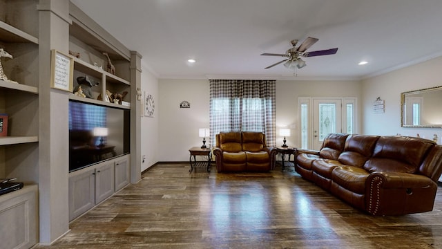 living room with dark hardwood / wood-style flooring, crown molding, and built in features