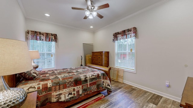 bedroom featuring ceiling fan, ornamental molding, and wood-type flooring