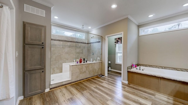 bathroom with wood-type flooring, crown molding, and independent shower and bath