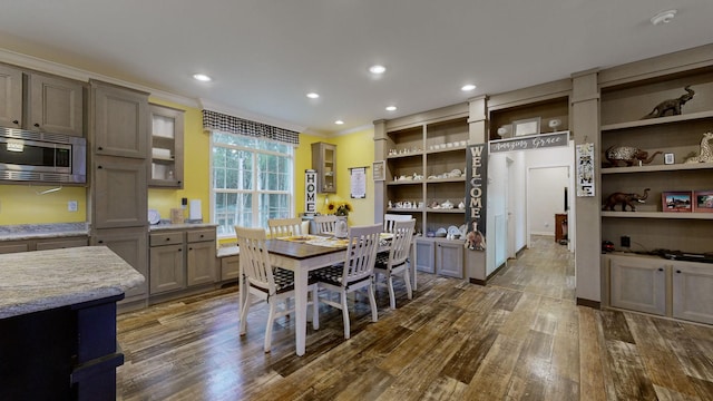 kitchen featuring gray cabinets, ornamental molding, and dark hardwood / wood-style floors