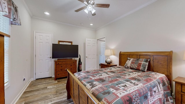 bedroom with ceiling fan, hardwood / wood-style flooring, and crown molding