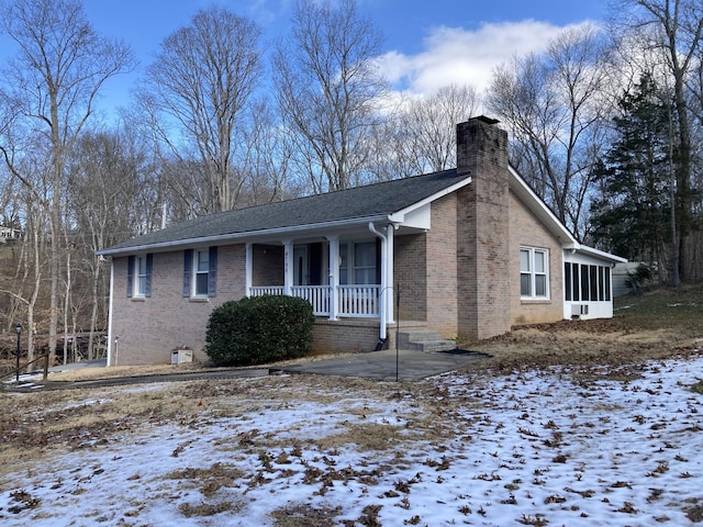 snow covered property featuring a porch