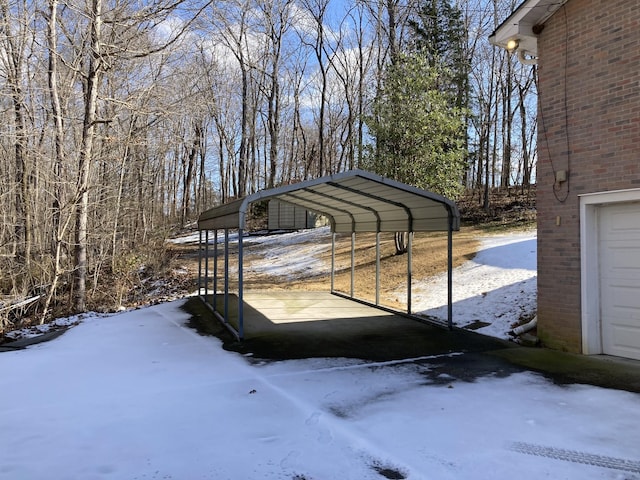 snow covered parking area with a carport