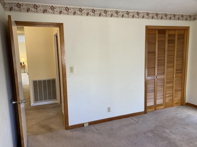 unfurnished bedroom featuring a closet and carpet flooring