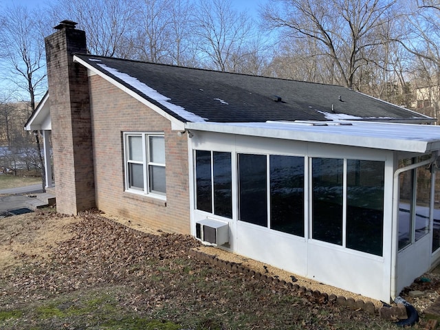 view of side of property with a sunroom