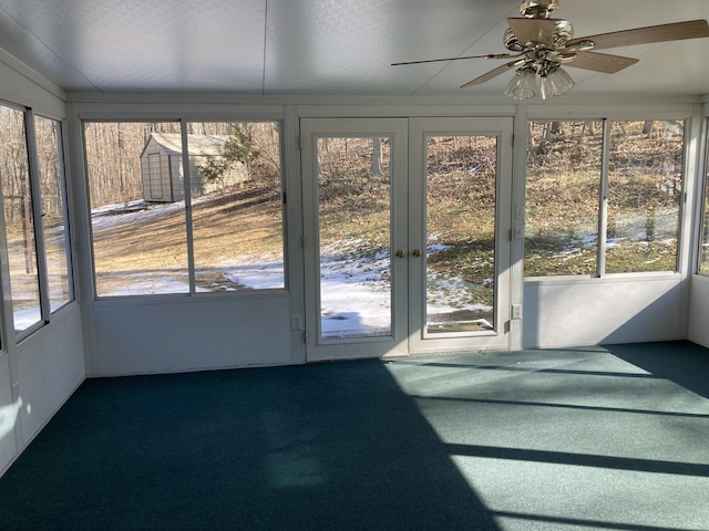 unfurnished sunroom with ceiling fan