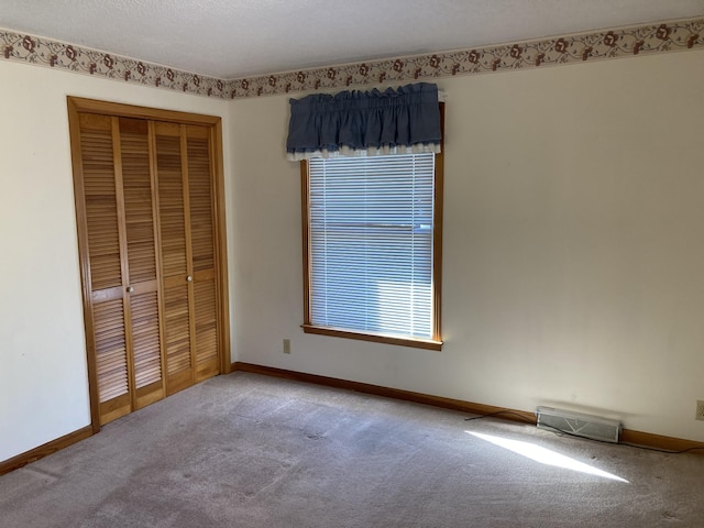 unfurnished bedroom featuring a closet and carpet