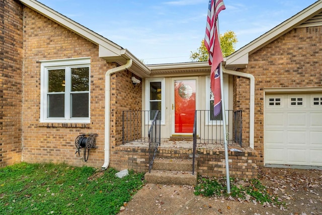 doorway to property with a garage