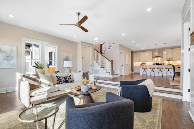 living room featuring ceiling fan and dark hardwood / wood-style flooring