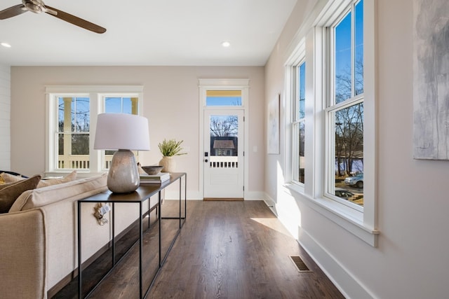 interior space with ceiling fan and dark hardwood / wood-style floors