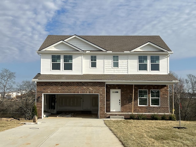 view of front of house with covered porch, a front yard, and a garage