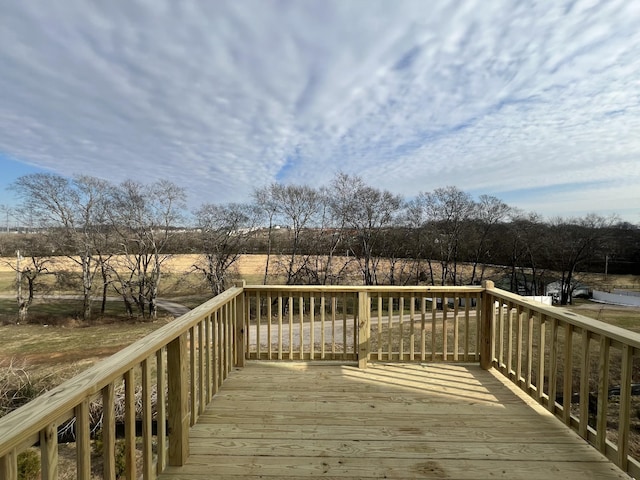 wooden terrace featuring a rural view