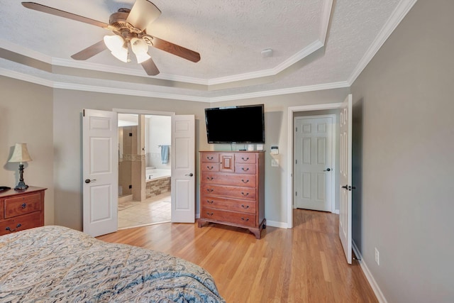 bedroom featuring light wood-type flooring, crown molding, ceiling fan, a tray ceiling, and a textured ceiling