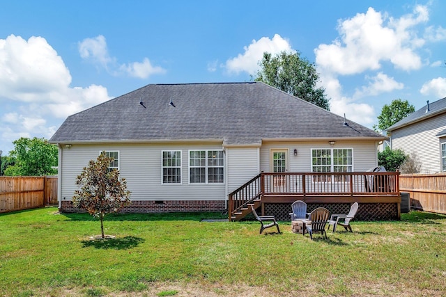 rear view of house with a yard, a deck, an outdoor fire pit, and central AC unit